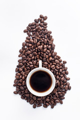 Cup of coffee arranged with fresh roasted coffee beans
