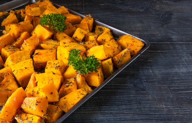 Baked pumpkin slices with spices and oil