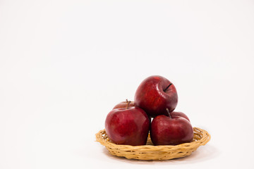 Ripe red apples in wicker basket isolated on white background