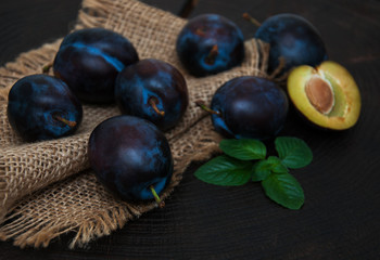 Fresh plums with green leaves