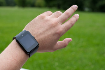 Man using smart watch outdoors