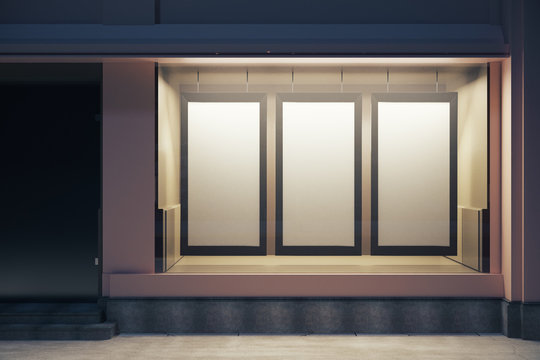 Storefront with blank posters at night