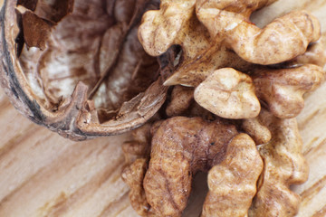 Walnut and nutshell on table.