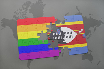 puzzle with the national flag of swaziland and gay rainbow flag on a world map background.