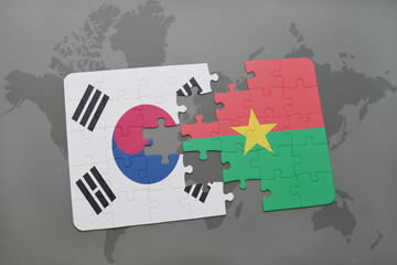 puzzle with the national flag of south korea and burkina faso on a world map background.