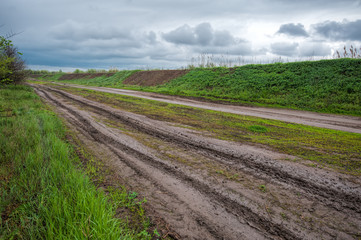 Fototapeta na wymiar Empty rural road on rainy april day.