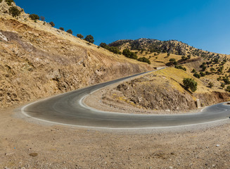 Road in Iraqi Countryside in Kurdistan region leading to high hills and mountains