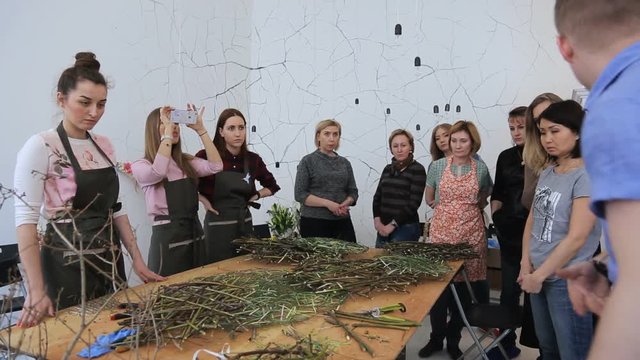 Man is conducting workshop of floral design.