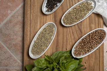 Fresh meat selection on black background with spices in a white bowl