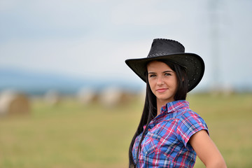 Young american cowgirl woman portrait outdoors. 