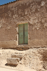 The door and steps of an old dilapidated house in Bolivia, El Alto, La Paz, Altiplano