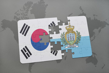puzzle with the national flag of south korea and san marino on a world map background.