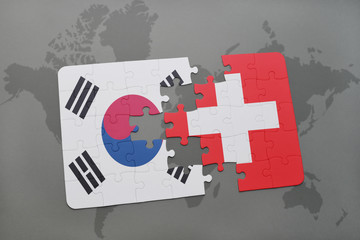 puzzle with the national flag of south korea and switzerland on a world map background.
