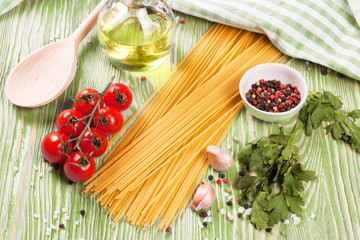 Pasta ingredients on green background.