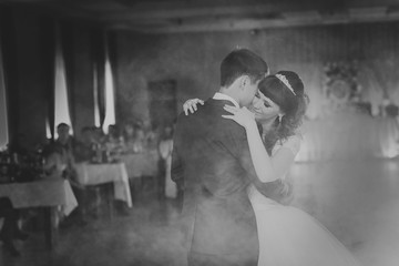 black and white photo first dance the bride  groom in the smoke