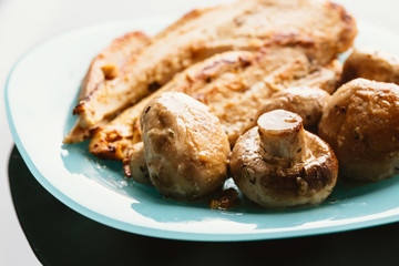 chicken with mushrooms in cream sauce on a blue plate