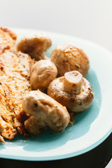 chicken with mushrooms in cream sauce on a blue plate