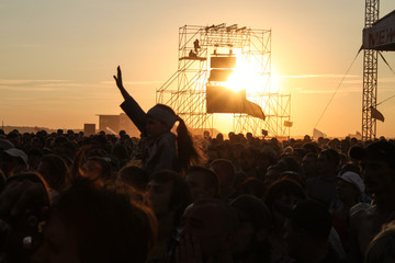 Samara 12.06.2010: Festival at sunset many people pull their hands up
