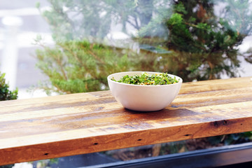 Green Salad Bowl on the light wooden surface. Healthy lunch