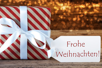 Fototapeta na wymiar Atmospheric Gift With Label, Frohe Weihnachten Means Merry Christmas