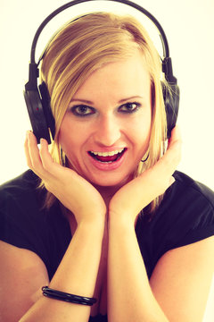 Blonde girl in big headphones.