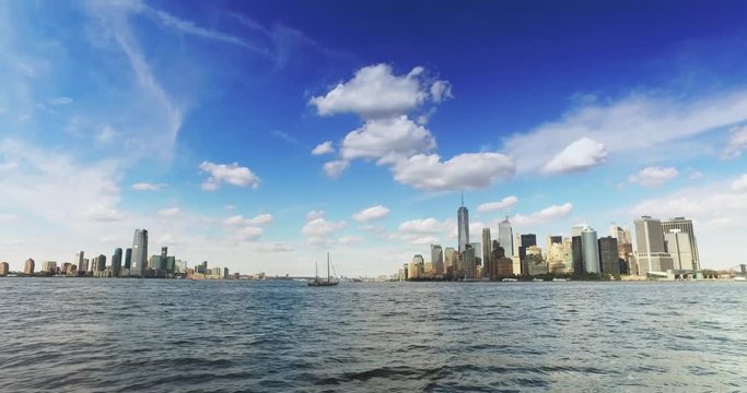 A daytime establishing shot of the lower Manhattan and Jersey City skyline as seen from New York Harbor.	 	