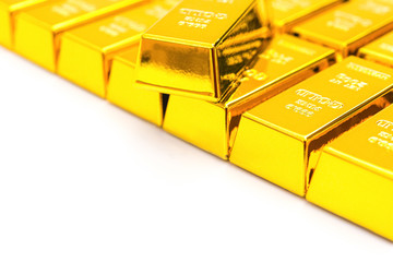 pieces of gold bars on white with copy space