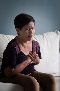 Senior Asian woman having heart attack.