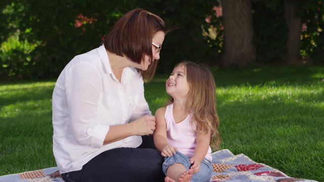 Mother and daughter having a picnic in the park - 4k