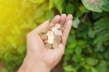 Hand of young man with coins