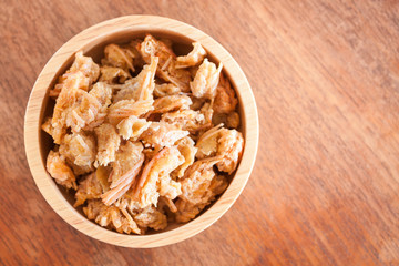 Fried shrimp chins snack in wooden bowl