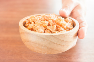 Fototapeta na wymiar Fried shrimp chins snack in wooden bowl