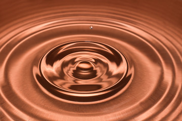 Drop of water, water splash in brown color.