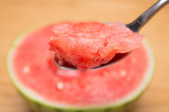 spoon taking out mouthful watermelon selective focus