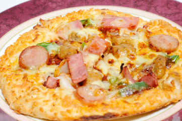 Barbecue pizza divided into four parts on antique plate