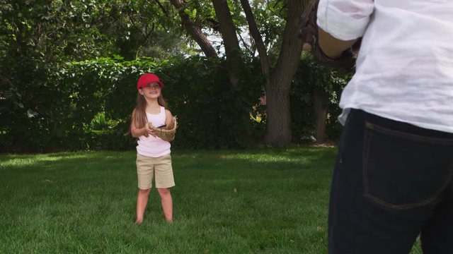 Mother and daughter playing catch in the park - 4k