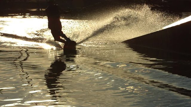 Slow motion shot of man wakeboarding