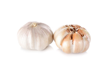 uncooked whole garlic with shell on white background