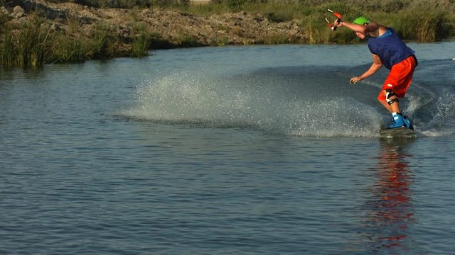 Slow motion shot of man wakeboarding - 4k