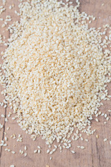 sesame seeds on wooden surface