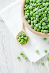 frozem peas on wooden surface