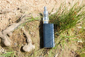 Electronic cigarette on green grass