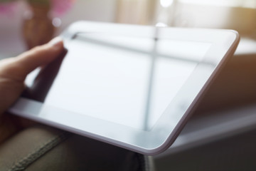 Female Holding White Business Tablet Next To A Window At Sunset