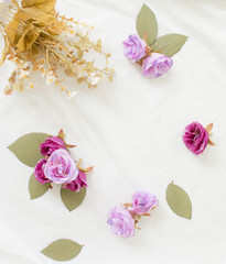 Purple flowers on white fabric background