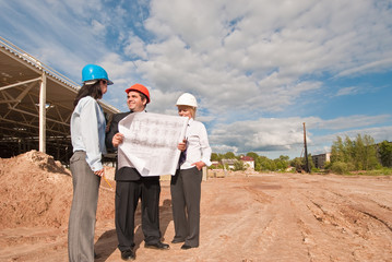 Director with subordinates on construction site of shopping cent