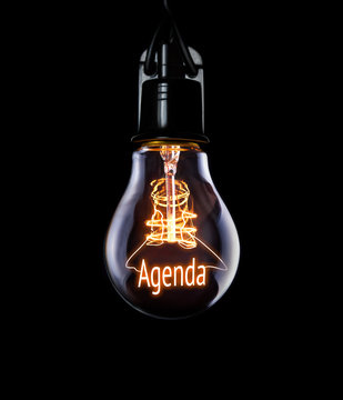 Hanging Lightbulb With Glowing Agenda Concept.