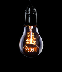 Hanging lightbulb with glowing Patent concept. - obrazy, fototapety, plakaty