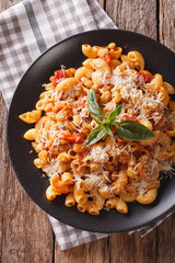 pasta with kidney bean and parmesan cheese on a plate close-up. Vertical top view
