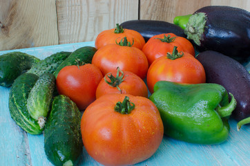 Vegetables stacked on a wooden table.