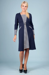 Beautiful young girl  posing on a blue background